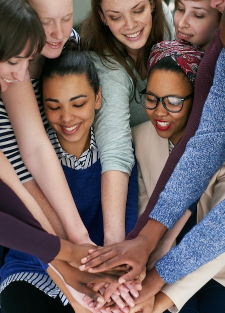 Feeling the team spirit Cropped shot of a group people putting their hands together in unity