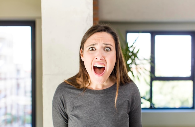 feeling terrified and shocked with mouth wide open in surprise