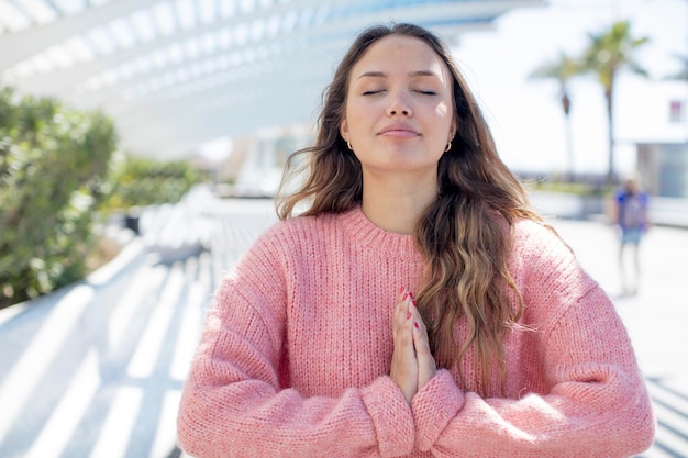 Feeling worried hopeful and religious praying faithfully with palms pressed begging forgiveness