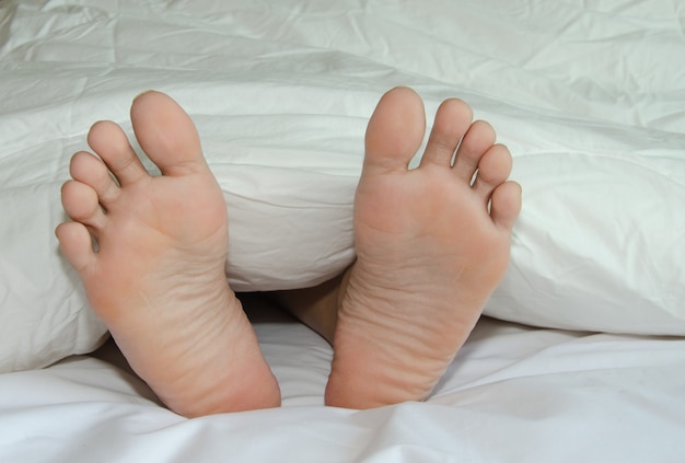 Feet are on the bed