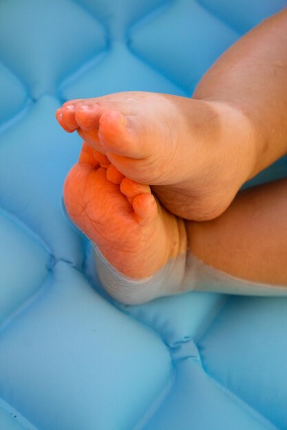 Feet of a baby submerged in the water during a bath