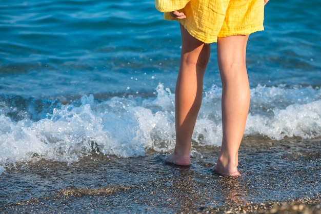 feet of a girl who goes barefoot into the sea concept sea vacation relaxation vacation