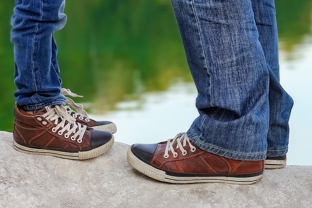 A Feet of happy parent and child in nature in the park travel