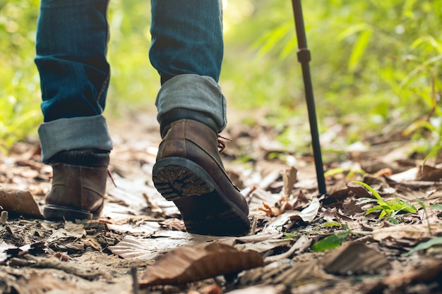 Feet Man hiking outdoor and forest on background Lifestyle Travel survival concept