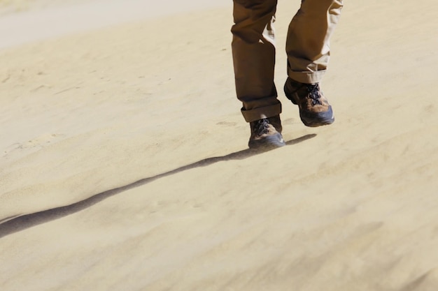 feet of a man walking in the desert