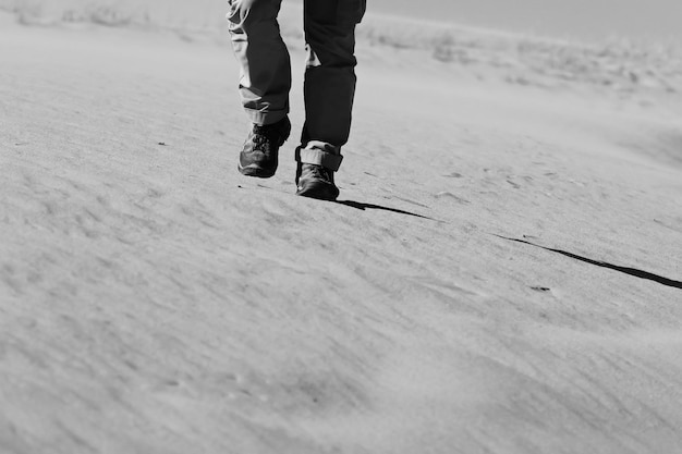 feet of a man walking in the desert