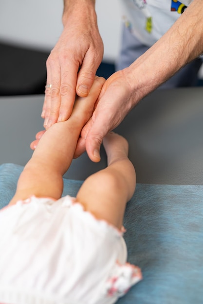 Feet massage making for child Tiny baby leg massaging