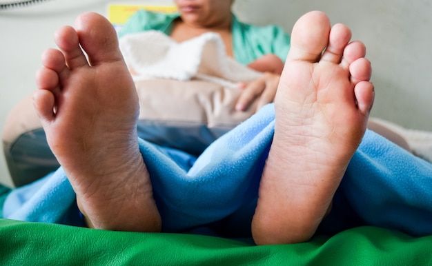 feet of mother and baby newborn