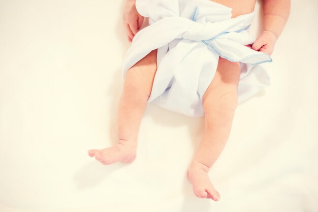 Feet of newborn baby in diaper with copyspace