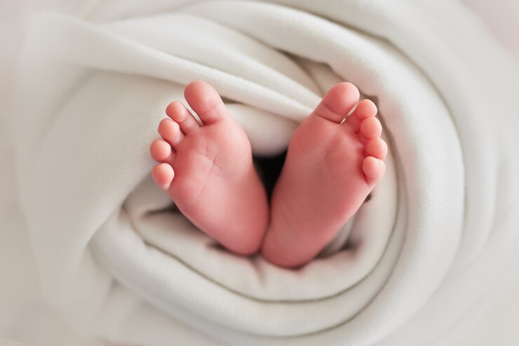 Photo feet of a newborn baby on a light 