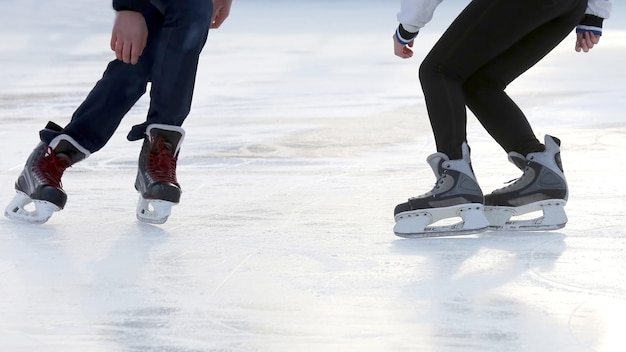 The feet of the people skating at the rink. 
Hobbies and recreation. Sports and holidays