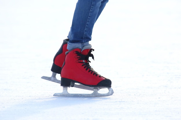 Feet in red skates on an ice rink