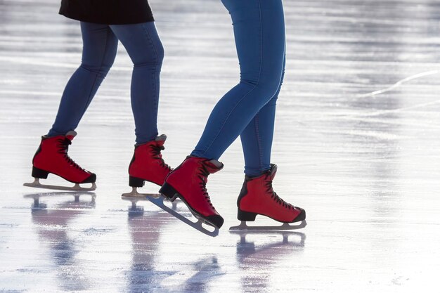 Feet in red skates on an ice rink