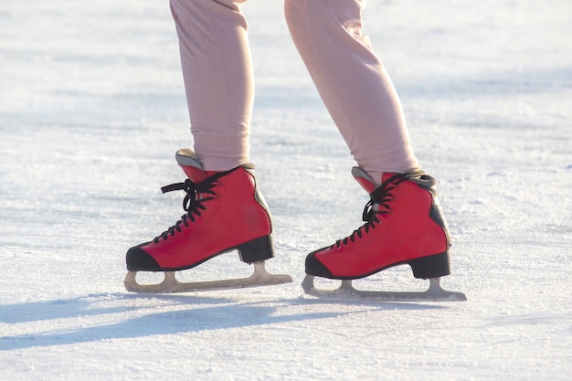 Feet in red skates on an ice rink