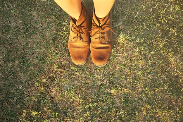 Feet in shoes on grass background