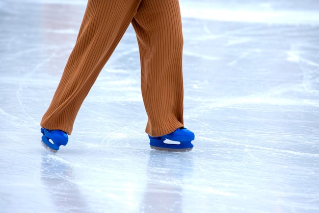 Feet on skates on an ice rink winter sport and recreation