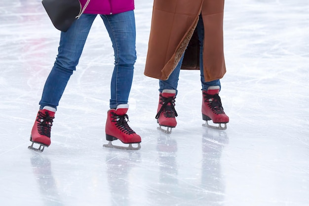 feet on the skates of a person rolling on the ice rink