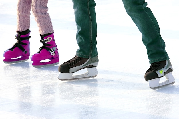 Feet skating on the ice rink. Sports and winter holidays