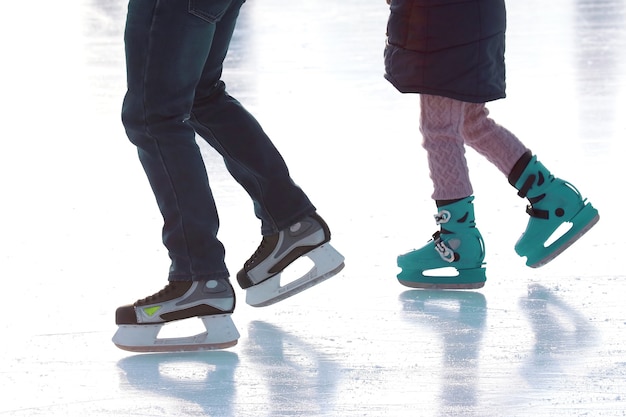 Feet skating on the ice rink. vacation sports and hobbies