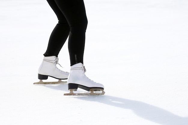 Feet skating on the ice rink