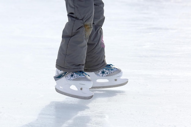 Feet skating on the ice rink