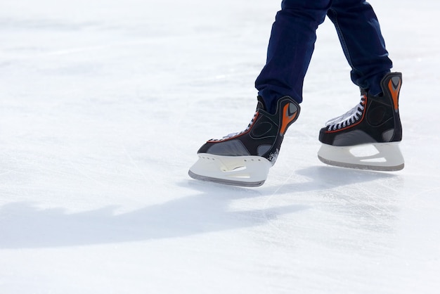 Feet skating on the ice rink