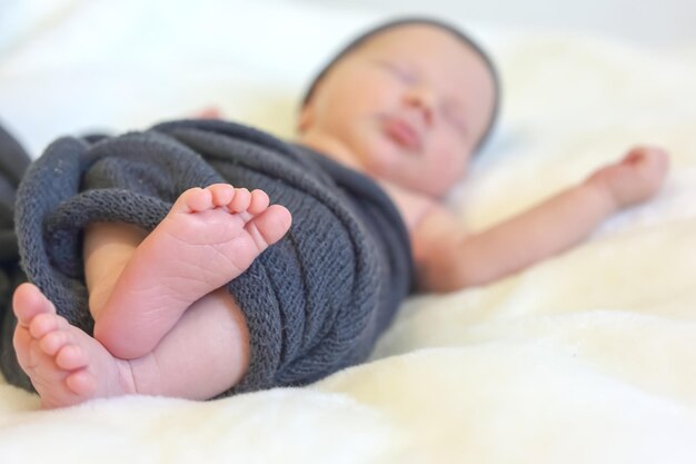 Feet of a sleeping newborn baby closeup