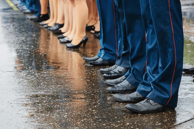 Feet of squad of policemen in boots on line