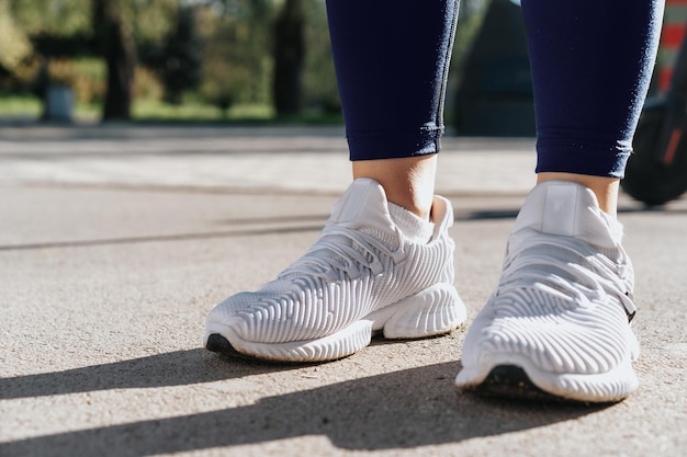 Feet of a woman dressed in sportswear and sneakers for\
running