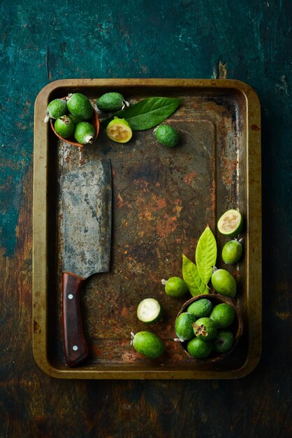 Feijoa Fresh feijoa fruits on a tray Top view on a black stone background