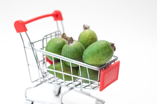 Feijoa fresh fruit in toys small supermarket trolley.