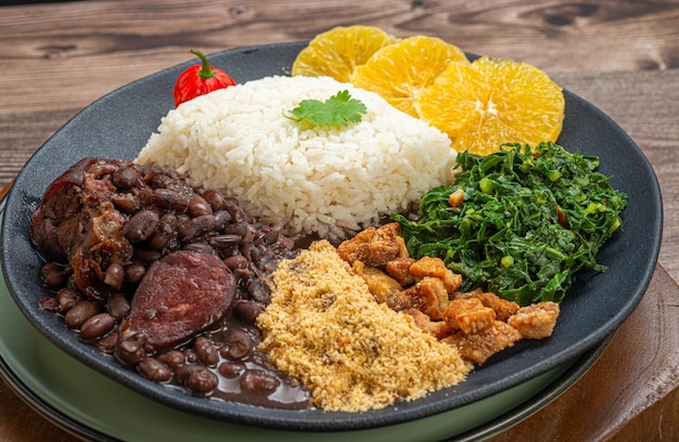 FEIJOADA typical and traditional Brazilian cuisine paired with Caipirinha and beer