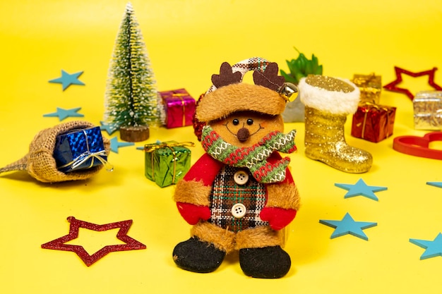 Photo felt doll dressed in winter clothes and featuring a christmas moment, with elements in the background