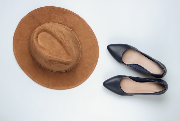 Felt hat, high heel shoes on a white