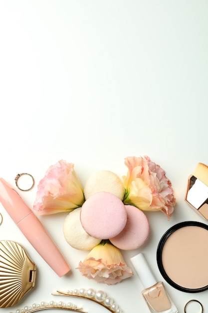 Female accessories and macaroons on white background