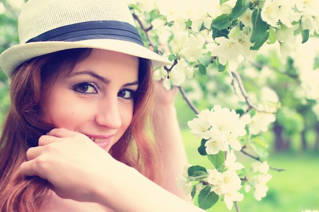 Photo female in apple tree flower