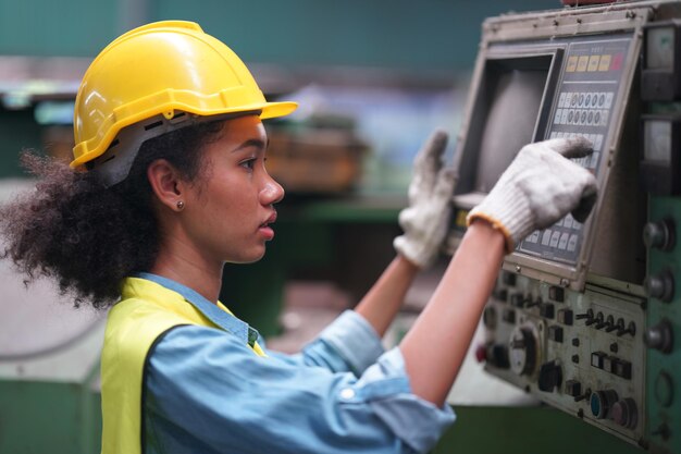 Female apprentice in metal working factory, Portrait of working female industry technical worker or engineer woman working in an industrial manufacturing factory company.