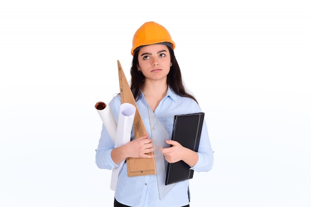 Female architect holding folders and blueprints.