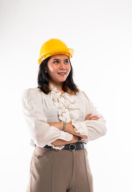 A female architect standing with handcrossed and looking up