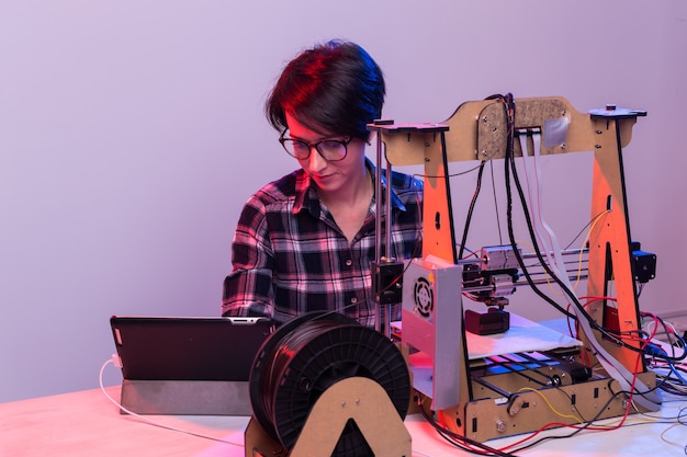 Female architect using printer in office.