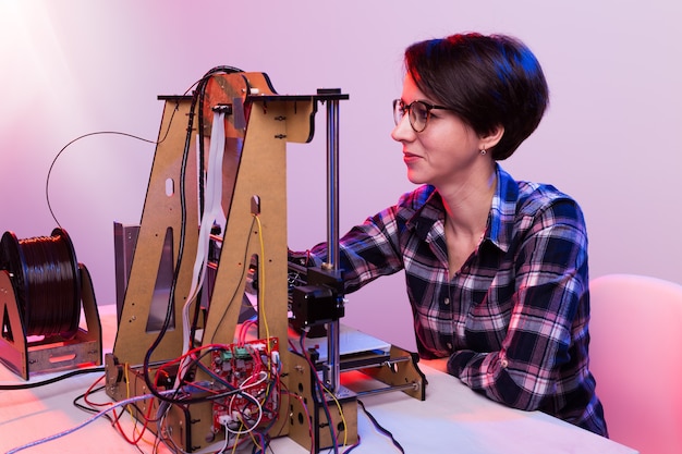 Female architect using printer in office.