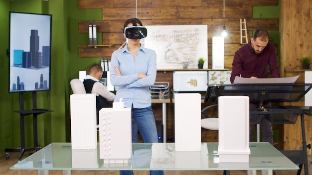 Female architects exploring virtual reality projects of business buildings. Future of architecture and building industry.