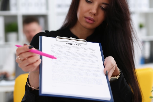 Photo female arm offer contract form on clipboard pad