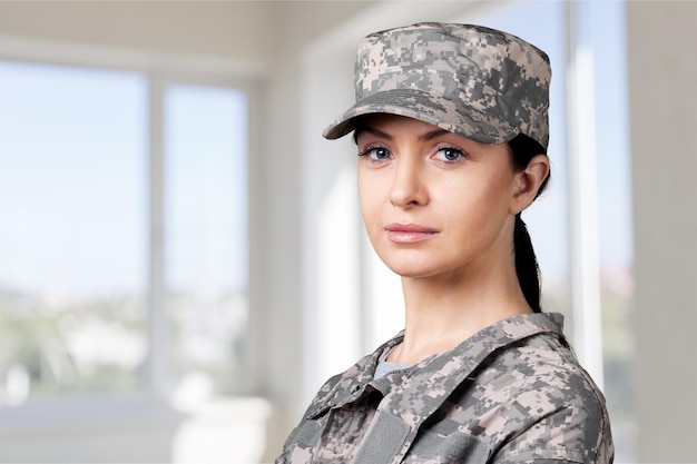 Female army soldier on grey background