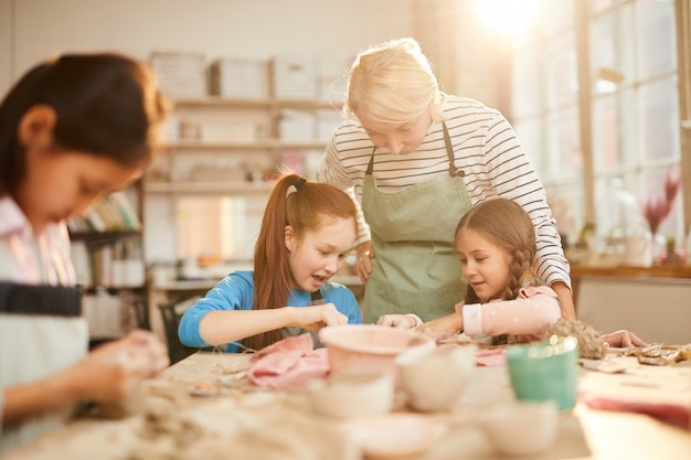 Female Art Teacher Working with Kids