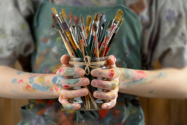 Female artist hands with paint brushes