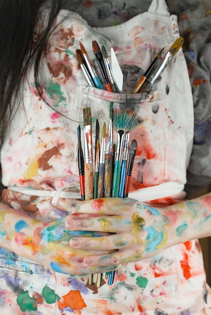 Female artist hands with paint brushes