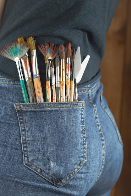 Female artist hands with paint brushes