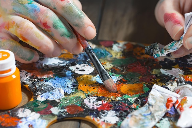 Female artist hands with paint brushes