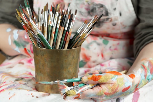 Female artist hands with paint brushes